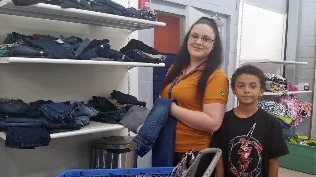 Mother and son shop for jeans in the Free Store