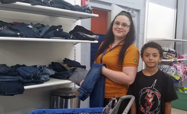 Mother and son shop for jeans in the Free Store