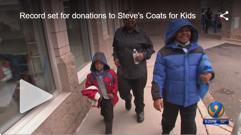 Image serves as link to view video on WSOC TV's site. Image shows Betty and her grandsons on the sidewalk with coats they selected free-of-charge at Crisis Assistance Ministry.