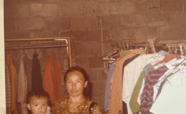 Woman holding a baby in the Free Store circa 1986
