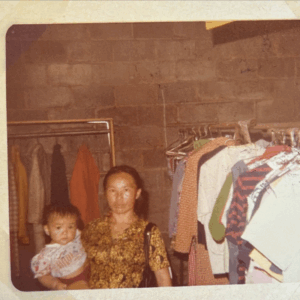 Woman holding a baby in the Free Store circa 1986