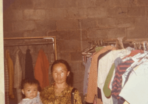 Woman holding a baby in the Free Store circa 1986